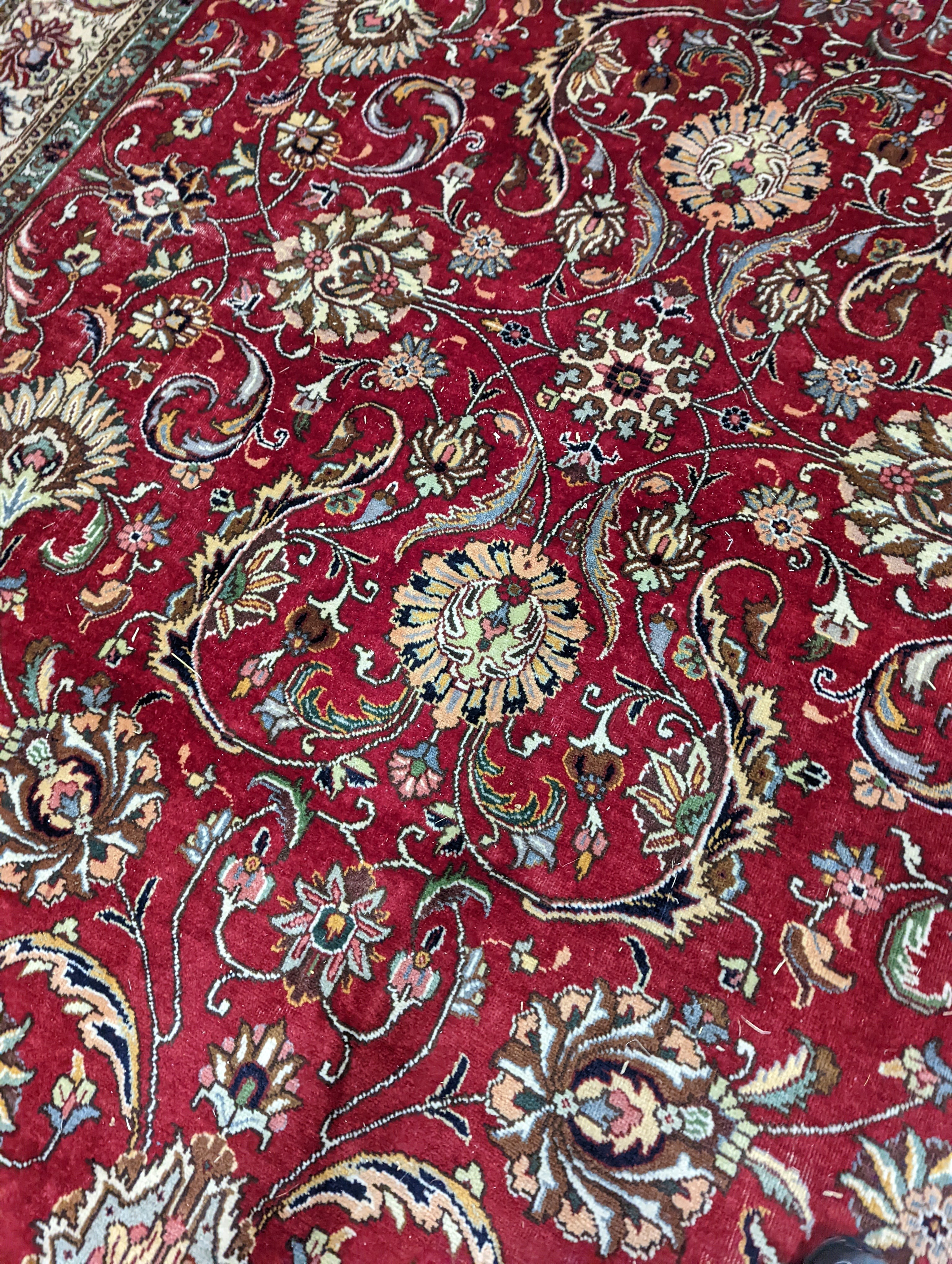 A Tabriz red ground carpet, 400 x 290cm